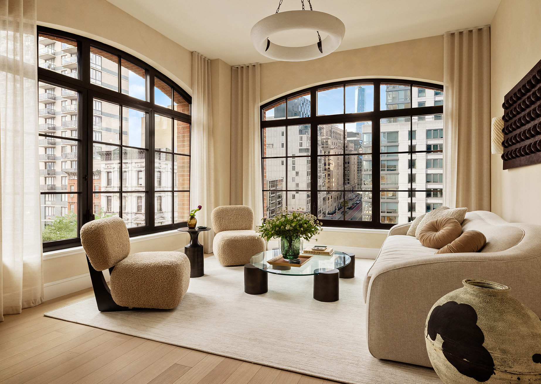 Living room at The Willow Gramercy with arched windows, neutral tones, and modern interior design.